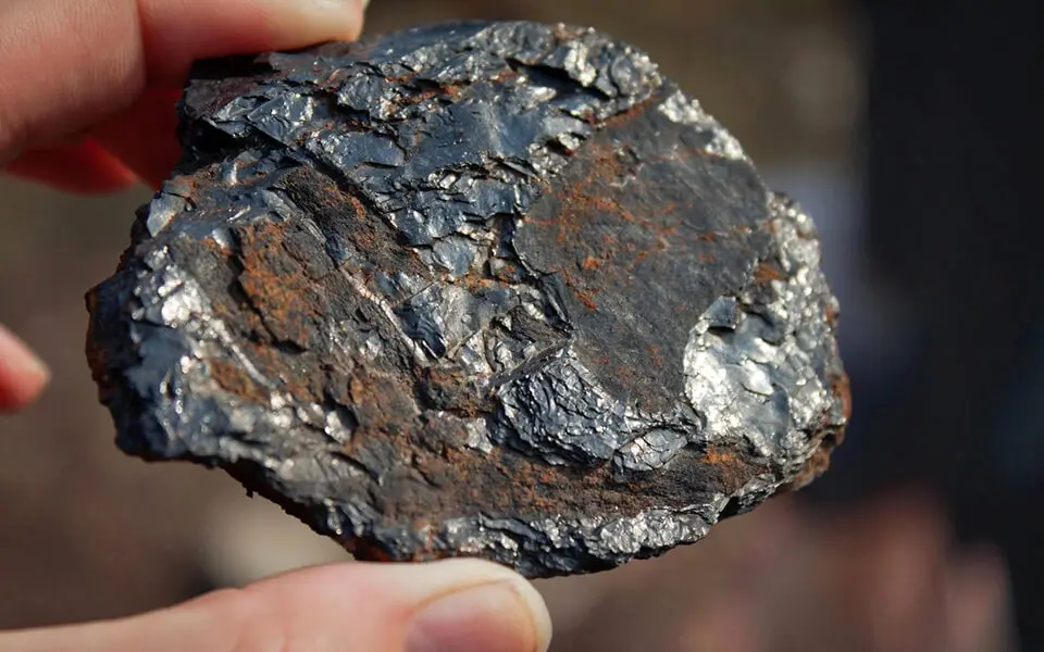 Piece of coal in hand